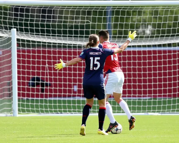 Defender Blocks Shot on Goal in Soccer Match Wallpaper