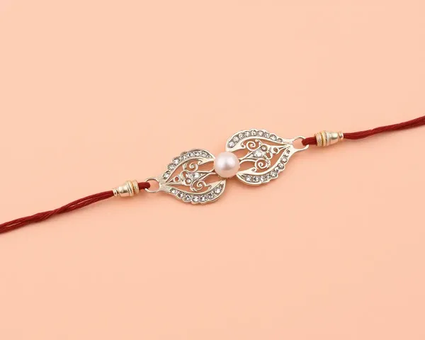 Delicate Filigree and Pearl on Soft Peach Background Fancy Rakhi