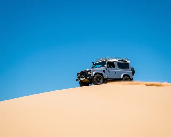 Land Rover Defender Off-Roading on Sandy Dune