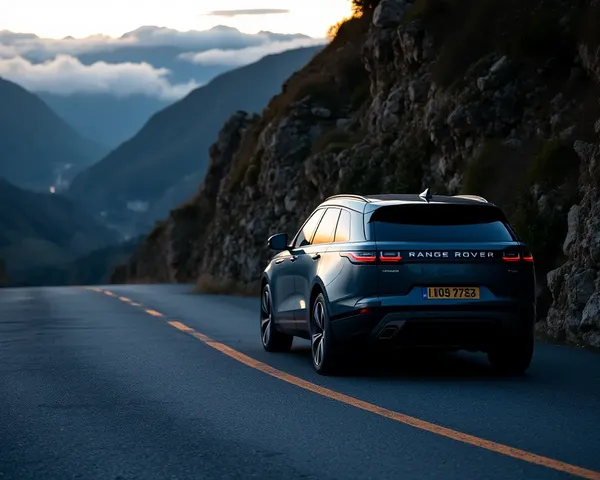 Luxurious Range Rover Velar on Winding Mountain Road at Sunset Wallpaper