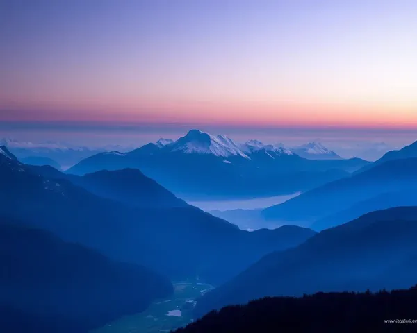 Majestic Mountain Range at Dawn with Blue Purple Hues Wallpaper