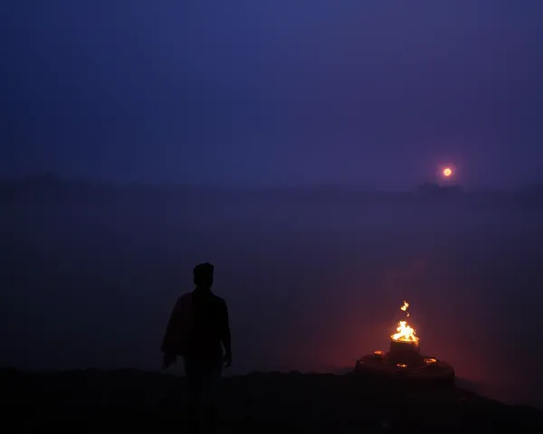 Moody Chhath Puja Ceremony at Dusk with Misty Riverbank