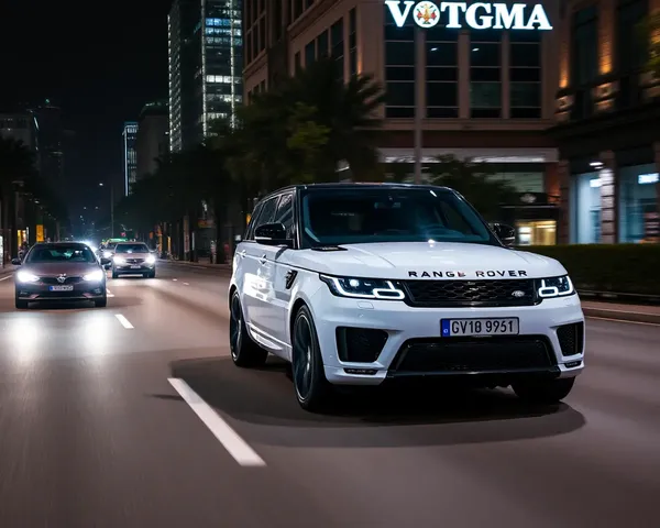 Range Rover Sport Drives on City Street at Night