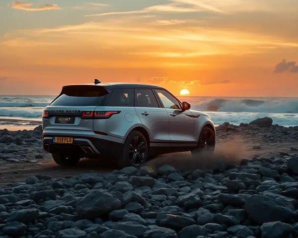 Range Rover Velar Drives on Rocky Beach with Waves Crashing