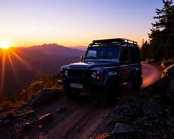 Rugged Land Rover Defender Conquers Mountain Trail Sunset