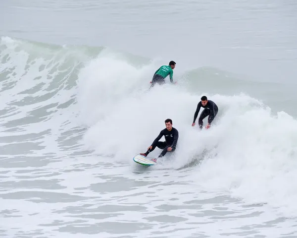 Surfers Ride the Waves at Jerman Seaford's White Foam