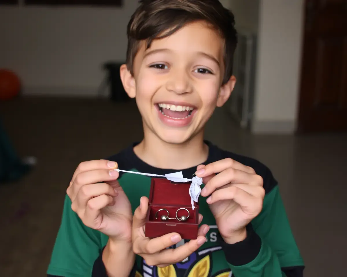 Boy Unwraps New Ear Rings with Big Smile and Excitement